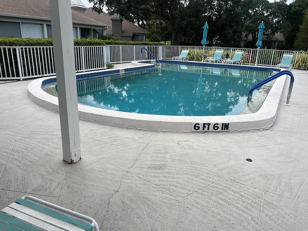 Before: Cracked concrete to paver pool deck