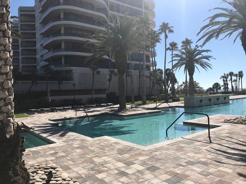Resort-style community pool deck installed by Paver Mac